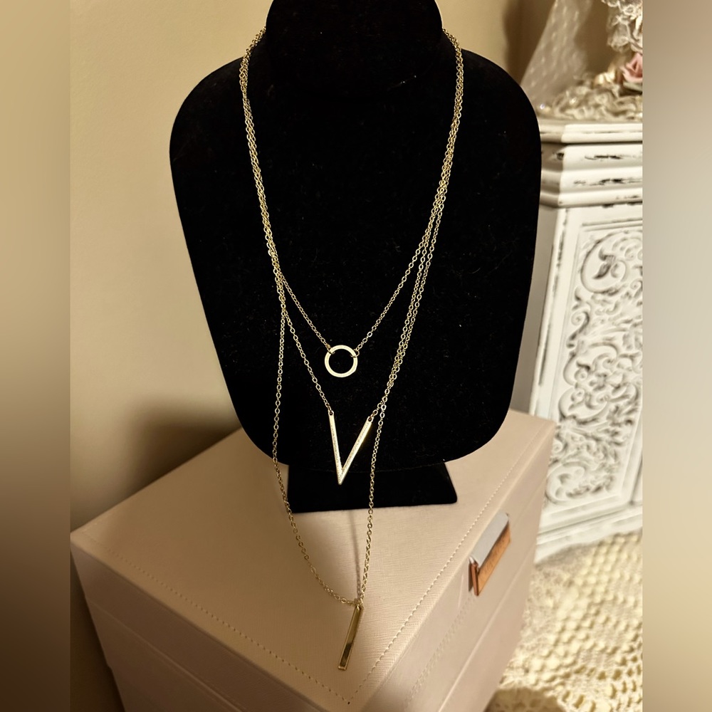 Gold necklace 3 strands held with one lobster clasp
Beautiful and dainty 
NWOT